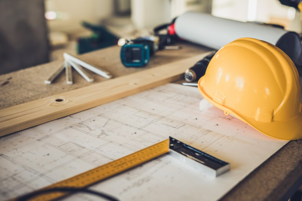 a yellow hard hat on a table with tools depicting digital marketing for home services