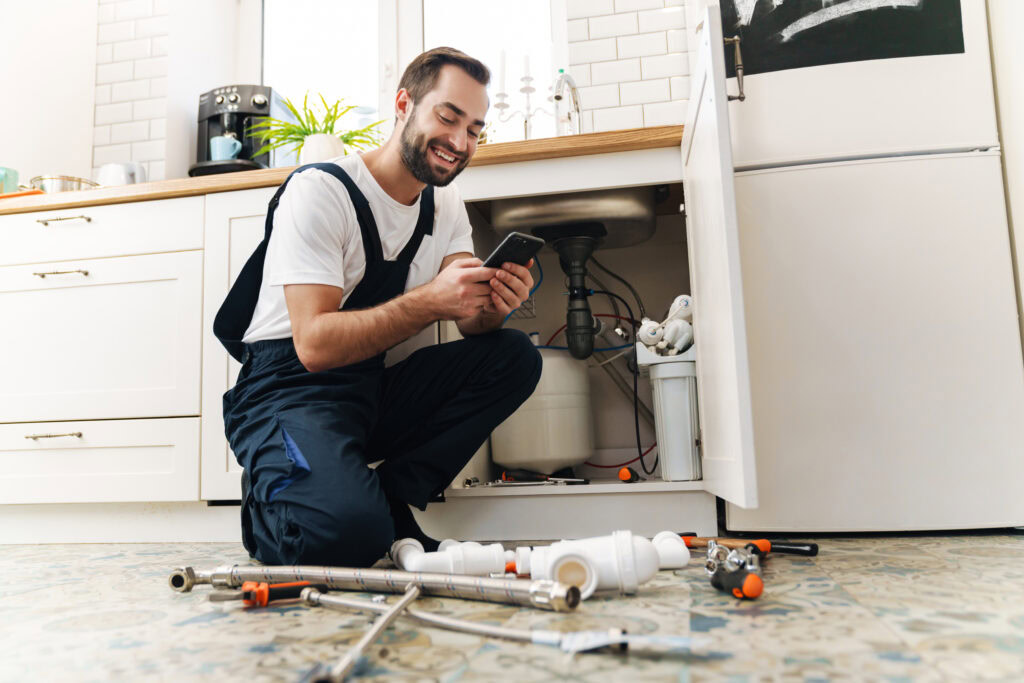 A plumber checking on how his digital marketing is performing on his phone.