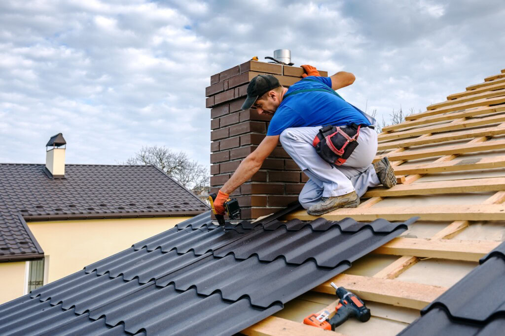Roofer with screwdriver covering repairs the roof